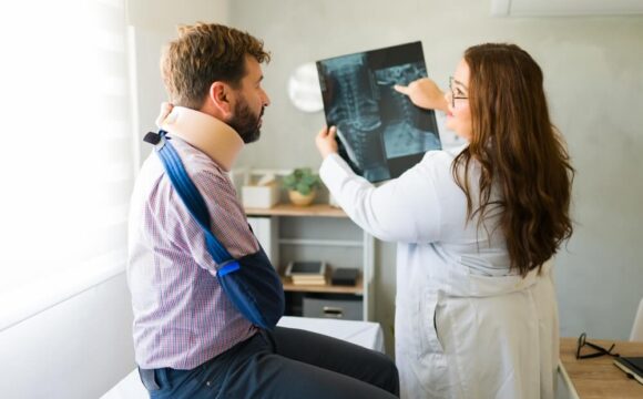 Doctor reviewing X-rays during a workers’ comp independent medical exam
